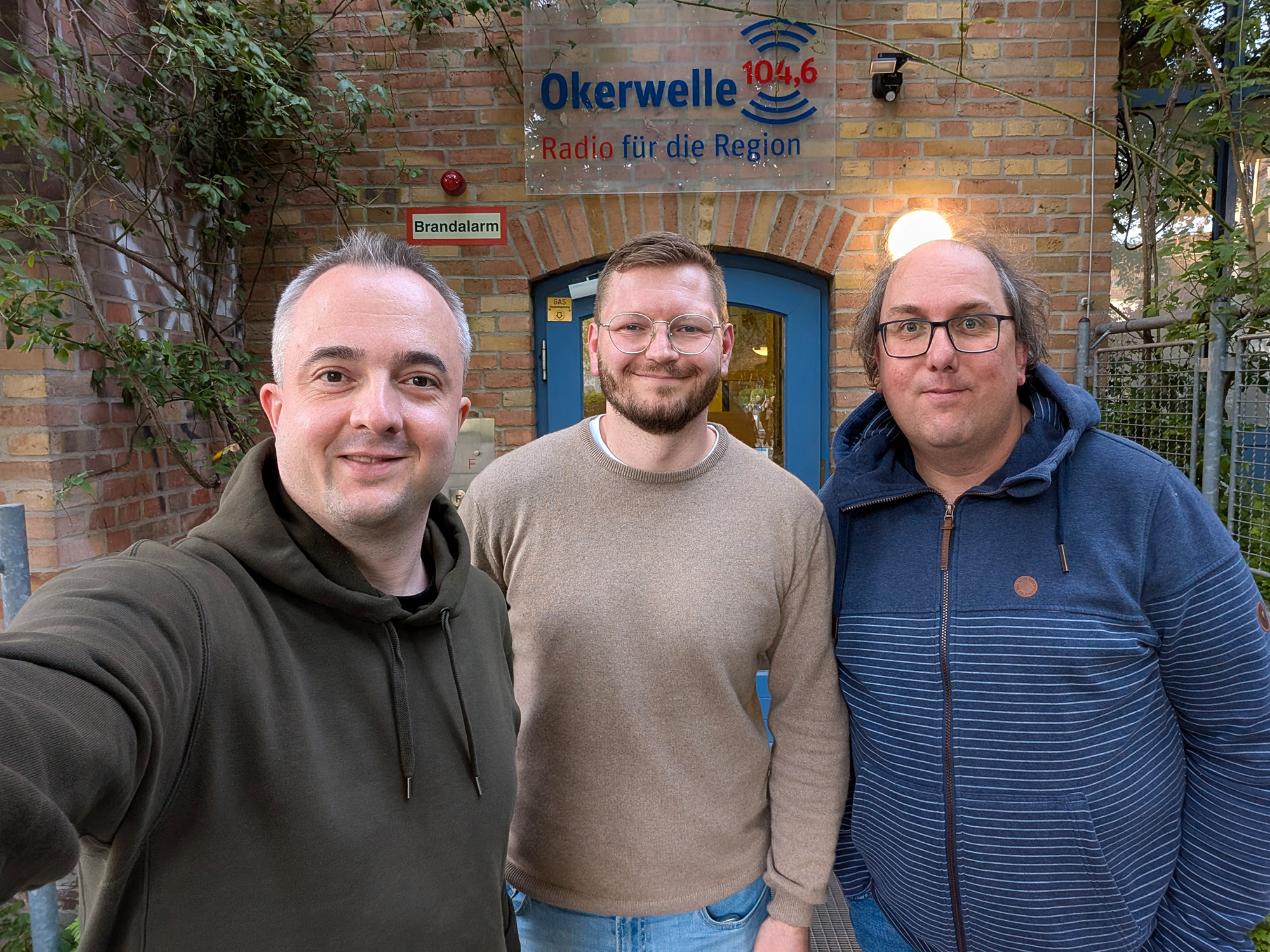 Die Moderatoren Markus Hörster und Christian Cordes mit dem Braunschweiger App- und Web-Entwickler Martin Appelmann nach Logbuch Digitalien Episode 98 vor dem Studio von Radio Okerwelle in Braunschweig.